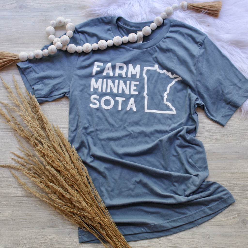 Teal tshirt with farm minnesota written in white print with an outline of minnesota on it.