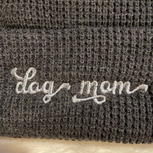 Heather Charcoal beanie with light grey "dog mom" embroidered on one side and a paw embroidered on the other side