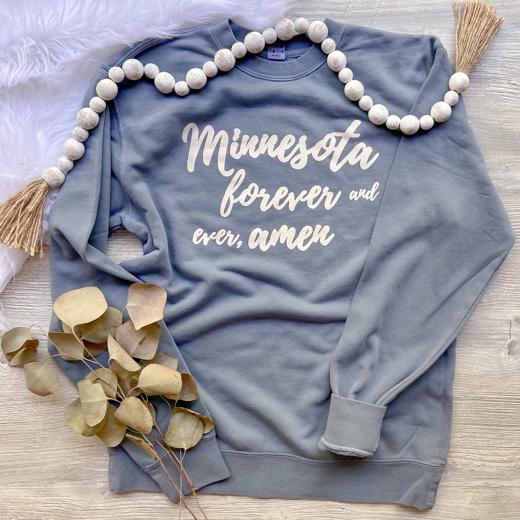 Blue crewneck that says Minnesota forever and and ever, amen on it in white text